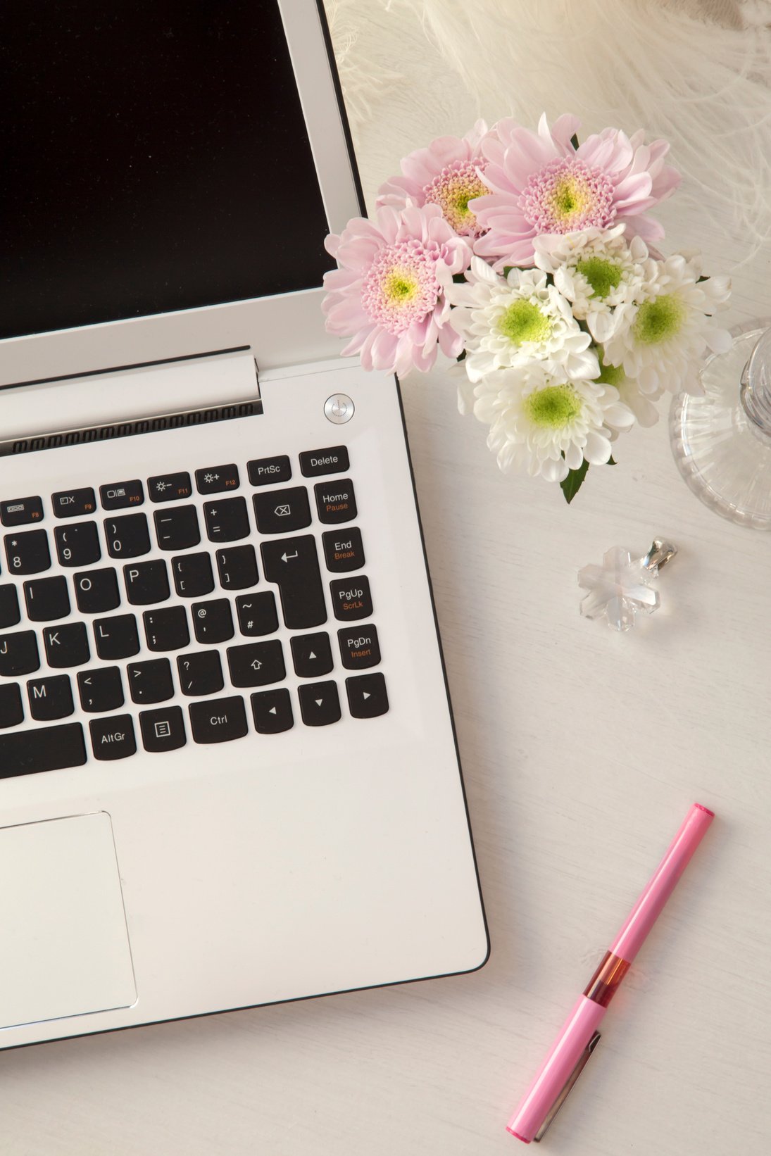 Laptop on desk with flowers